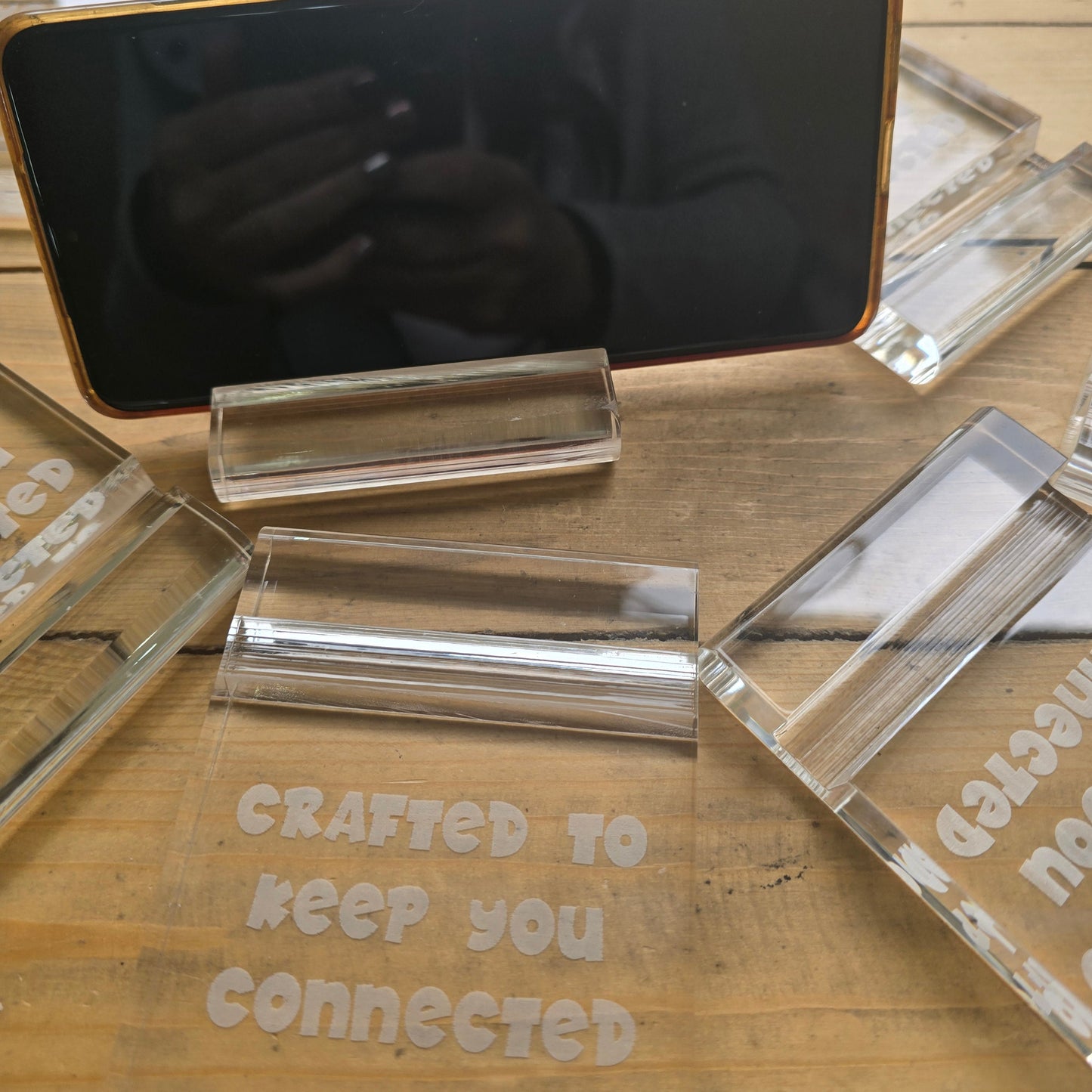 Minimalist plexi phone and tablet holder with engraved message. A stylish, functional stand for any desk or nightstand. The perfect everyday gift!