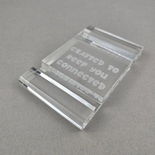 Minimalist plexi phone and tablet holder with engraved message. A stylish, functional stand for any desk or nightstand. The perfect everyday gift!